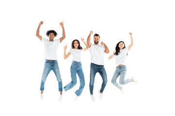 Obraz premium excited multiethnic friends in jeans looking at camera while levitating on white.