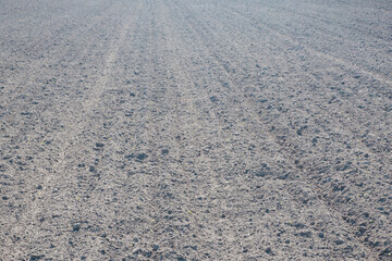 Photo of a plowed field. The texture of black soil after machining. Agriculture. Soil preparation for sowing