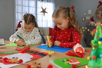 Fototapeta premium Cute little children making beautiful Christmas greeting cards at home