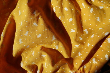 Rumpled amber yellow cotton fabric with birds print