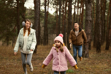 Happy family spending time together in forest
