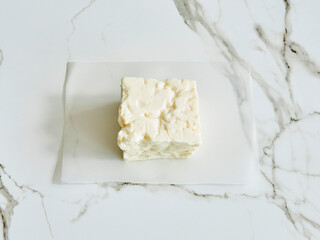 Cheddar cheese in package, natural lifestyle, dairy products, marble background.
