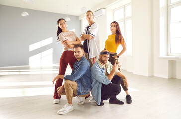 Group portrait of diverse young people dancers pose together in studio advertise school or classes. Millennial dancing crew or team in modern club. Hobby and activity. Performance and entertainment.