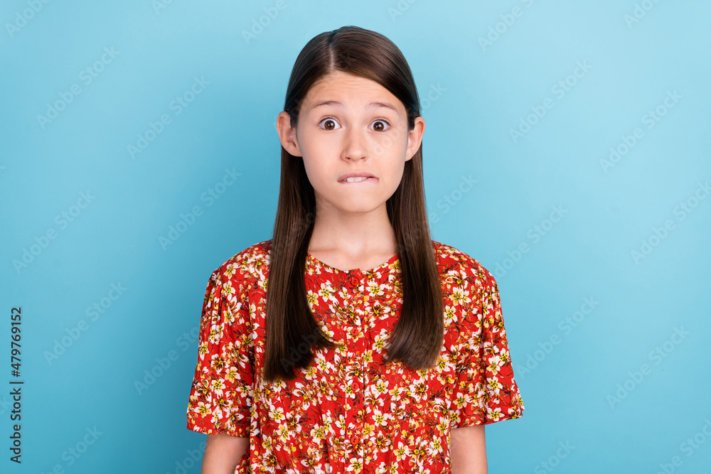 Sticker Photo of young pretty girl bite lips teeth worried scare failure isolated over blue color background