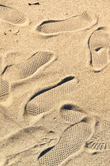 Fototapeta na wymiar Footprints on the sand, leisure activity concept