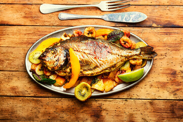 Baked fish dorado with pineapple, mango and kiwi.