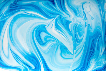 abstract acrylic liquid painting, blue color mixed with white color, pour painting with acrylic paint