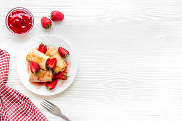 Sweet breakfast - rolled pancakes with strawberry and berry sauce