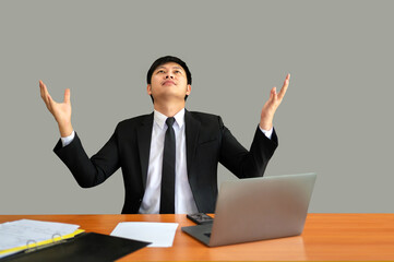 To find inspiration.Young businessman successful, using  computer and show hands while sitting at his workplace in the office.