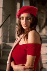 Naklejka na ściany i meble Portrait of a girl in a red beret.