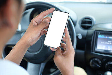 Close up view businessman sitting in car and using smart phone. Blank screen for your advertising text.
