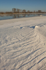 winter landscape. morning frost and sun. ice drift on the river. the branches of plants are covered with white frost