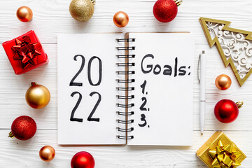 Goals hand writing list in notepad - inspirational and motivating concept