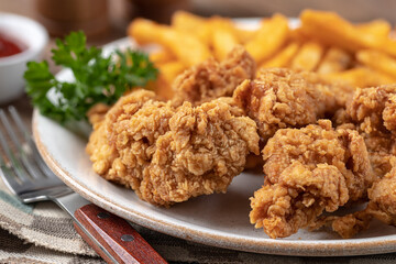 Crispy fried chicken tenders and french fries