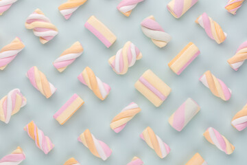 Colorful marshmallow laid out on pastel background. Creative textured pattern.