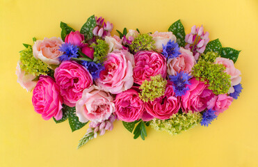 Composition of colorful beautiful flowers, on yellow background. Flowers spring or summer. Floral concept.