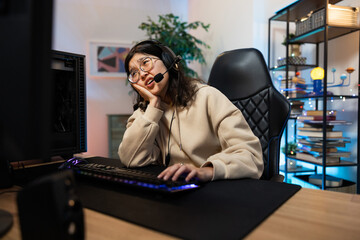 Bored woman loses game on computer she survives whines disappointed, she supports herself with hand...