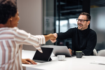 Fototapeta premium Happy adult caucasian man with glasses, approving of his colleagues idea.