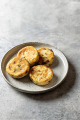 Syrniki or cottage cheese fritters with chocolate on ceramics plate