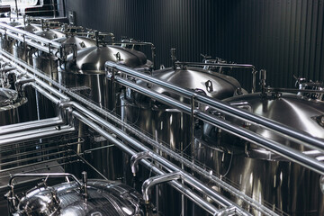 Modern Beer Factory. Steel tanks for beer fermentation and storage. Brewery. Modern beer plant with...