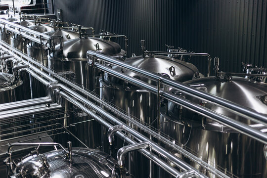 Modern Beer Factory. Steel tanks for beer fermentation and storage. Brewery. Modern beer plant with brewering kettles