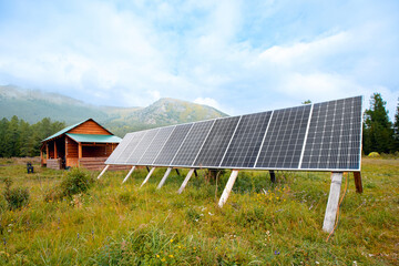 Scandinavian country cottage with solar panels surrounded by mountains, autonomous life