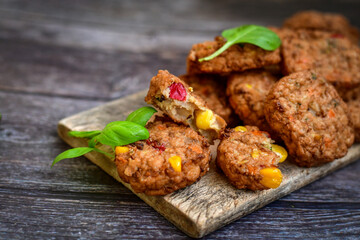 Home made  oven baked meatballs  from  chicken and vegetables and french potato  fries on  wooden background.Bifteki, or spicy meatballs 