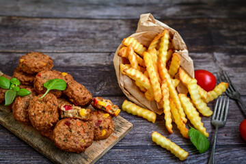 Home made  oven baked  mini meatballs  from  chicken and vegetable on  wooden background