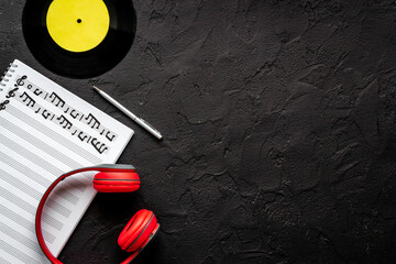 Sheets with music notes and headphones. Compose music concept
