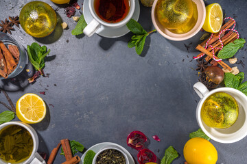 Various tea ball bombs. Assortment of different tea balls with dried tea, cups, lemon and mint, top view copy space. Trendy modern tea variety