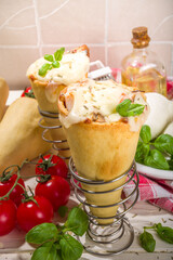 Trendy Cone pizza, modern pizza recipe, with tomatoes, basil, mozzarella cheese, baked pizza cones dough, ham and mushrooms