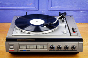 Vintage turntable vinyl record player with black vinyl