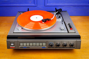 Vintage turntable vinyl record player with red vinyl