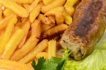 grilled andouillette with french fries and salad leaves