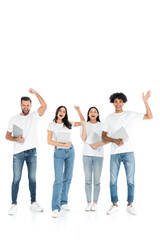 Obraz premium full length view of excited multiethnic friends with laptops showing success gesture on white.