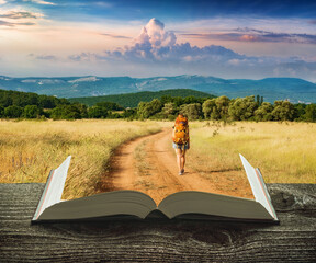 Girl hiker on a trail on the pages of book - 479784920