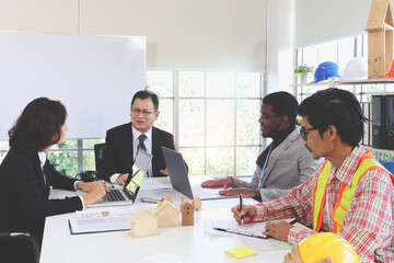 Four engineer business people discussing while sitting at meeting table in office together, multi-ethnic colleagues team working at the workplace, variety worker ethnic group do brainstorm meeting.