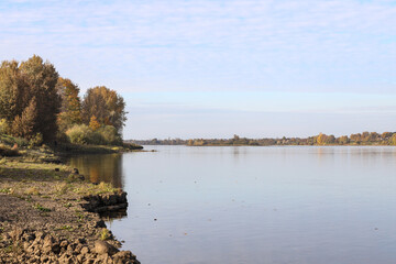 Autumn landscape view near river with autumn trees.