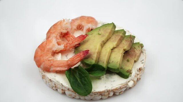 Closeup view of avocado and shrimp bruschetta or toast. Delicious food