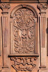 Closeup of mascaron carved in wood on old church door in Bratislava