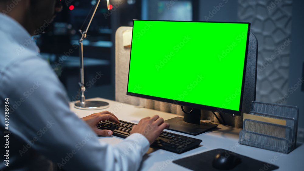 Poster Close Up of a Businessman Working on Desktop Computer with Chroma Key Green Screen Mock Up Display. Male Executive Director Managing Digital Projects, Typing Data, Using Keyboard and Mouse.
