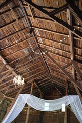 Wooden roof with cloth banner decoration and string lights.