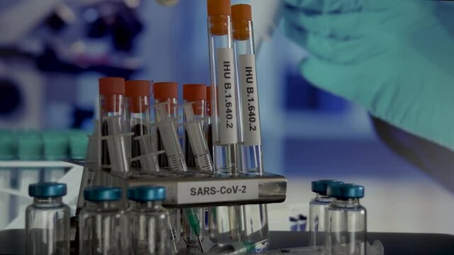 SARS COV 2 IHU B.1.640.2 Variant Samples In Laboratory Test Tubes Being Removed From Rack. Locked Off