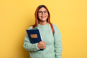 hispanic woman looking happy and pleasantly surprised. student concept