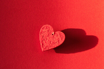 a red heart shaped decoration on a red background