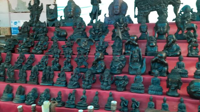 Indian gods statues stall in a market in Mumbai, India. The market street on Elephanta island in India. souvenir stalls in Elephanta island in Mumbai, India