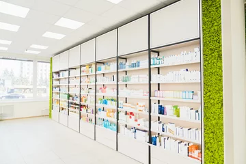 Zelfklevend Fotobehang Empty pharmacy chemist`s store drugstore with white shelves full of medicines, jars with drugs, pills, remedy, antibiotics, vitamins. Copy space © InsideCreativeHouse