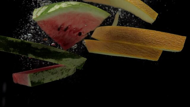 Slow motion slice watermelon and melon falling into transparent water on black background. Fresh fruits splashing in aquarium. Organic fruit, healthy food, diet, air bubbles