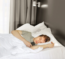 young sleeping man lying on the bed