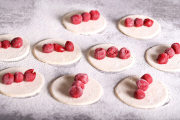 dumplings with frozen cherries are prepared in the kitchen
